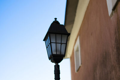 Low angle view of street light against building