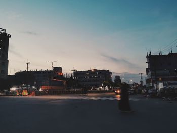 Buildings in city against sky during sunset