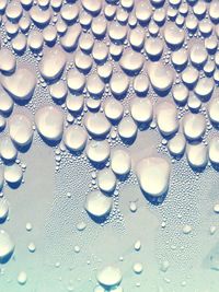 Close-up of water drops on condensed glass