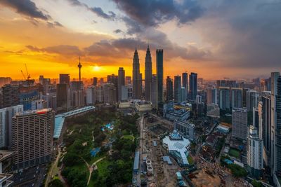 High angle view of modern buildings against sky during sunset