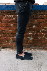 Low section of man standing on ground