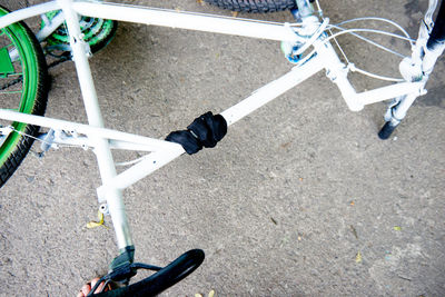 Low section of person riding bicycle on road