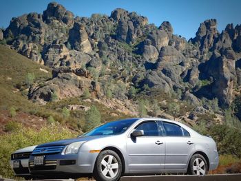 View of car on road against rocky mountains