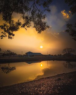 Scenic view of lake against orange sky