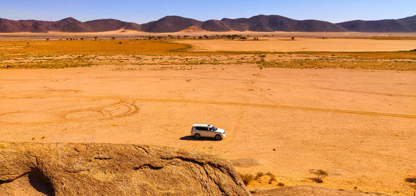 View of car on desert land