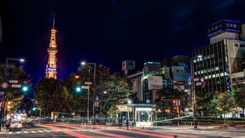 Illuminated city street at night