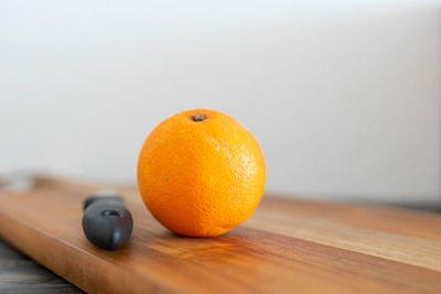 Close-up of orange fruit on cutting board