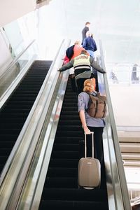 Rear view of people on escalator