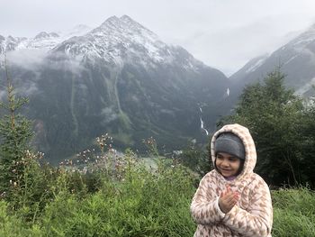 Close-up of girl against mountains