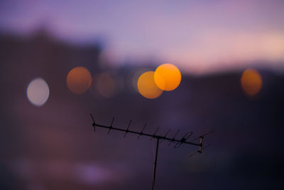 Low angle view of antenna pole against sky at sunset