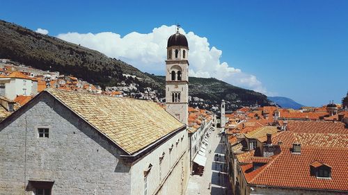 Buildings in town against sky