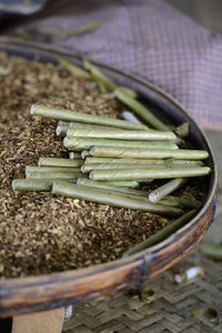 Close-up of beedis on tobacco in wicker container