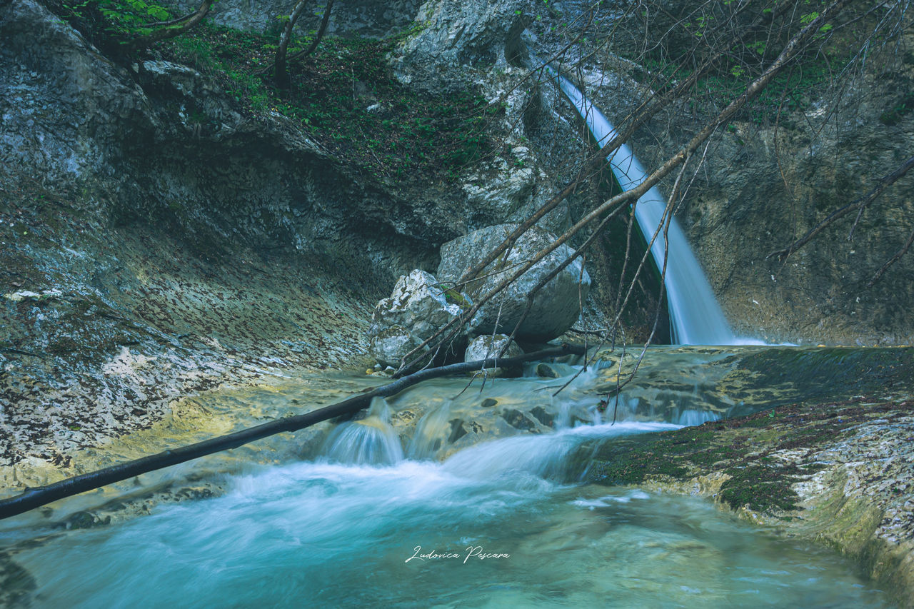 WATER FLOWING THROUGH ROCKS