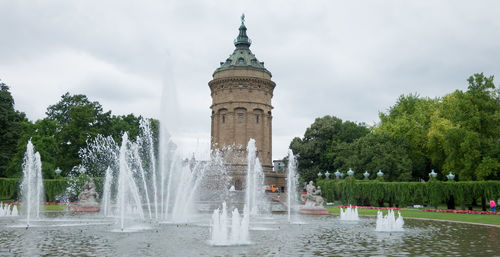 Fountain against mannheim water tower