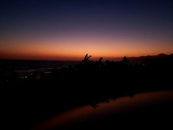 Scenic view of sea against orange sky