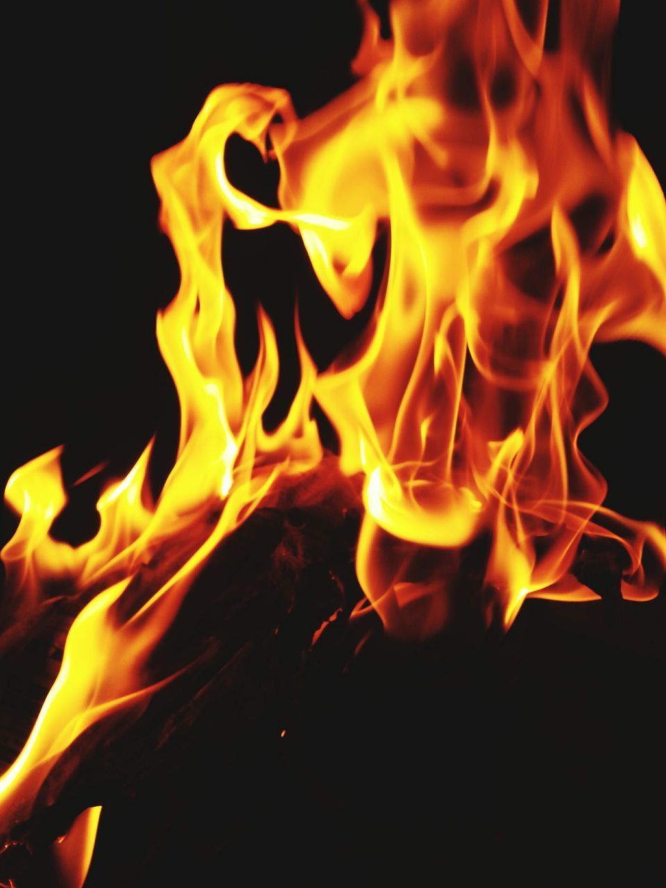 CLOSE-UP OF BONFIRE AT NIGHT DURING SUNSET