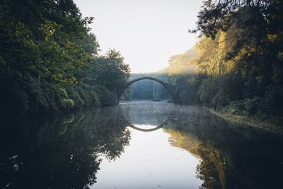 Arched remote bridge with water reflection 