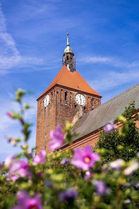 Gothic church tower with a clock in darlowo. 