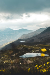 Scenic view of sea and mountains against sky