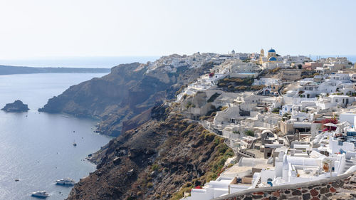 High angle view of town by sea against clear sky