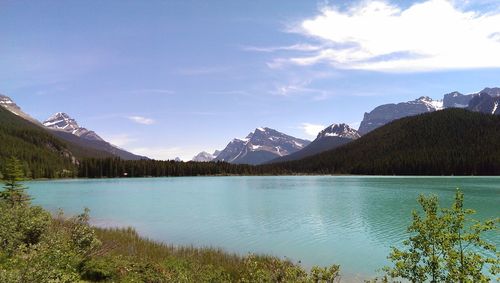 Scenic view of lake and mountains against sky