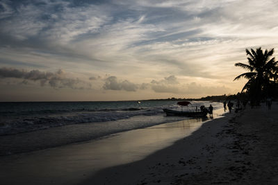 View of beach against cloudy sky