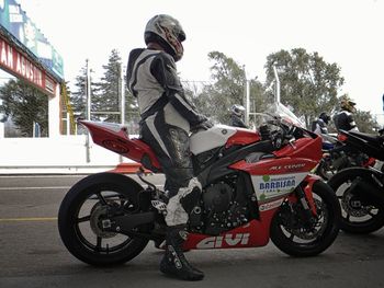 Man riding motorcycle on road in city