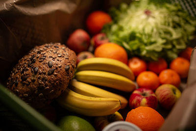 Close-up of fruits, vegetables and bread on table