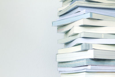 Close-up of stack of books against wall