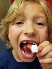 Close-up portrait of boy eating food