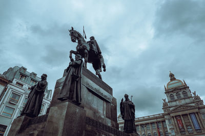 Low angle view of statue of building against cloudy sky