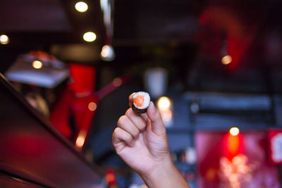 Cropped image of hand holding cigarette