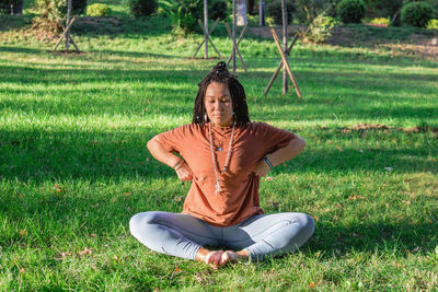 Woman is doing yoga asana outside in a park. concept of balancing and healthy lifestyle.