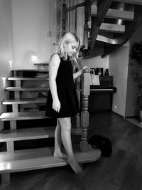 Full length of girl standing on steps at home