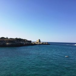 Scenic view of sea against clear blue sky