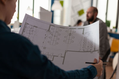 Midsection of businessman working at office