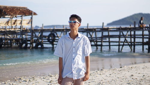 Man in sunglasses standing at beach