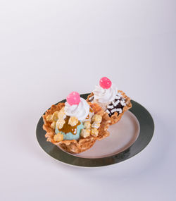 Cake on plate against white background