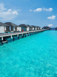 Scenic view of swimming pool by sea against sky