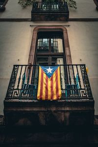 Low angle view of flag against building