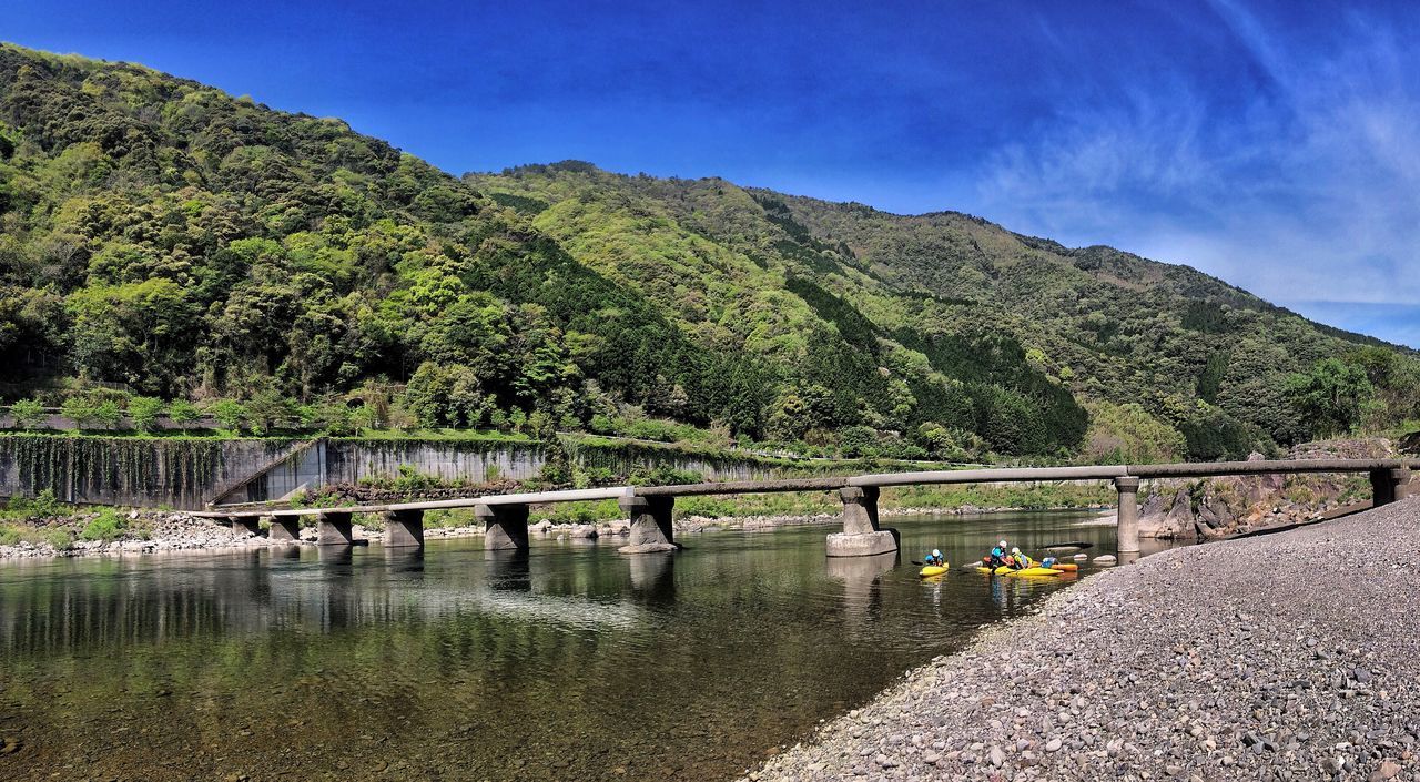 mountain, tranquility, tranquil scene, mountain range, scenics, beauty in nature, sky, water, tree, railing, nature, landscape, bridge - man made structure, blue, connection, river, built structure, lake, non-urban scene, idyllic