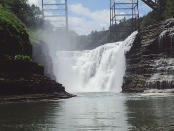 Scenic view of waterfall against sky