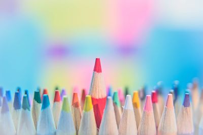 Close-up of colored pencils over white background