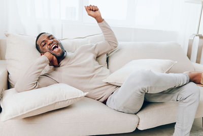 Couple sitting on sofa at home