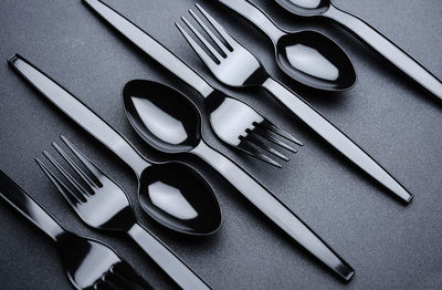 Close-up of forks and spoons arranged on table