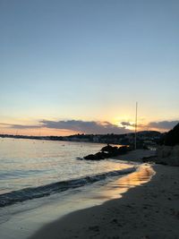 Scenic view of beach against sky during sunset