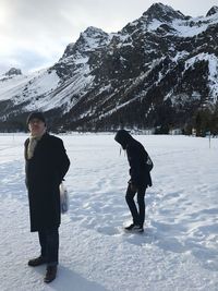 Full length of people standing on snow