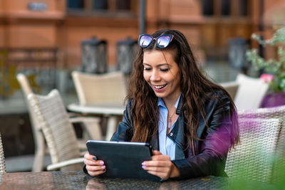 Young woman using digital tablet on table