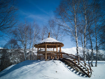 Built structure on snow covered land against sky