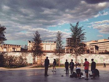 Buildings in city against cloudy sky